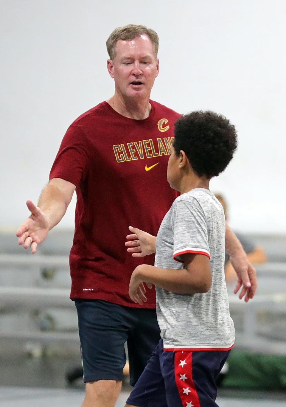 Former Cavaliers point guard Mark Price high fives a child after a basket during his skills camp at SWISH 365 Training Center, Wednesday, July 26, 2023, in North Canton.