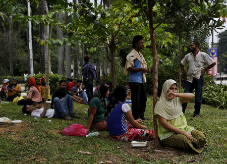 FILE PHOTO - Refugees, many of whom say they are Rohingya, wait for access to the United Nations High Commission for Refugees (UNHCR) building in Kuala Lumpur, Malaysia, August 11, 2015. REUTERS/Olivia Harris/File Photo