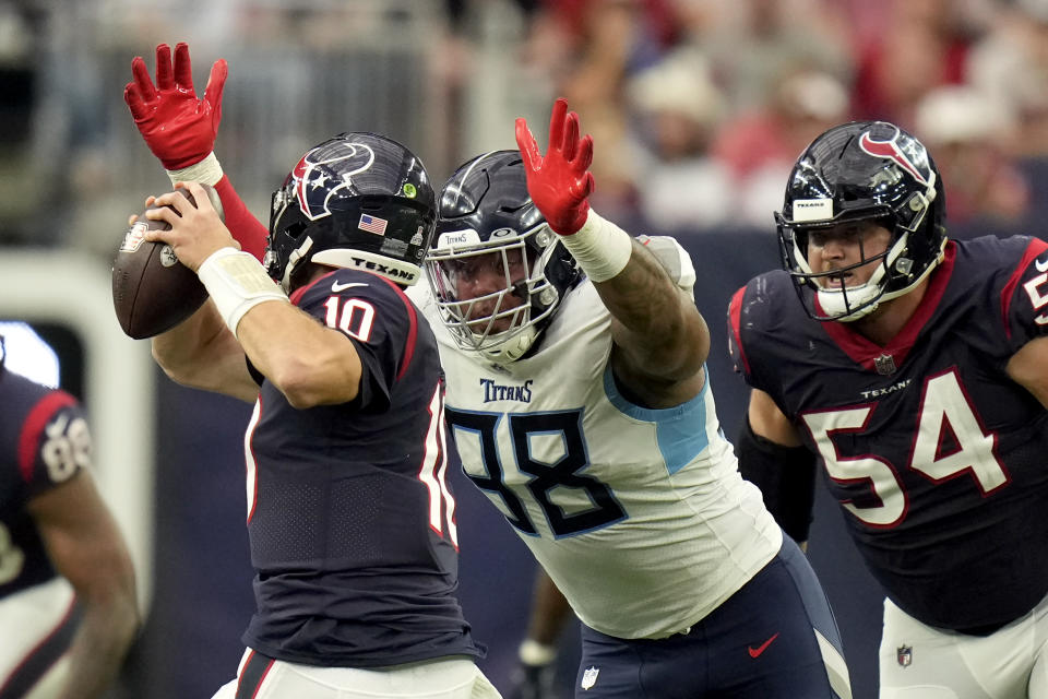 Tennessee Titans defensive tackle Jeffery Simmons (98) closes in on Houston Texans quarterback Davis Mills (10) for a 12-yard sack during the second half of an NFL football game Sunday, Oct. 30, 2022, in Houston. (AP Photo/Eric Christian Smith)