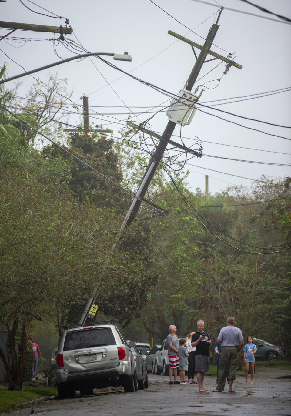 As the outer eye wall passes by New Orleans, residents come out to assess the damage from Hurricane Zeta on Wednesday, Oct. 28, 2020. (Chris Granger/The Times-Picayune/The New Orleans Advocate via AP)