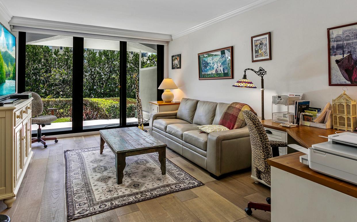 The owners use the second bedroom, with a pull-out sofa, as a den. They also replaced the original marble floors with hardwood.