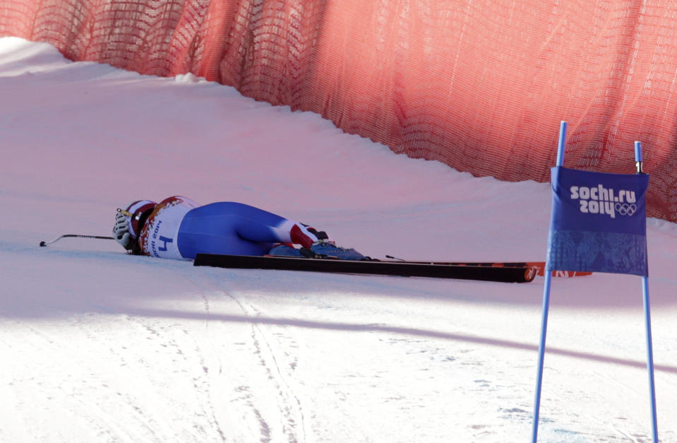 France's Marie Marchand-Arvier lies on the course after crashing into safety netting during the women's downhill at the Sochi 2014 Winter Olympics, Wednesday, Feb. 12, 2014, in Krasnaya Polyana, Russia. (AP Photo/Charles Krupa)