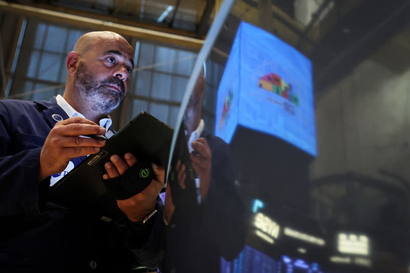 Traders work on the floor of the NYSE in New York