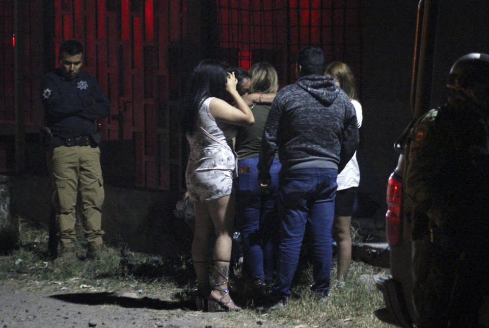 Relatives of some of the victims of a shooting at a nightclub comfort each other outside the premises, in the Apaseo el Grande municipality, Guanajuato state, Mexico, on March 12, 2023. / Credit: STR/AFP via Getty Images