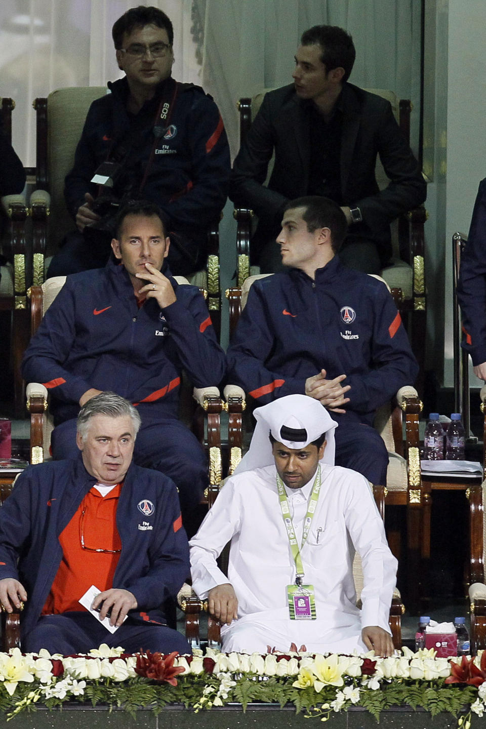 FILE - In this Jan. 2 2012 file photo, Paris Saint Germain's new coach Carlo Ancelotti of Italy, left, and president of PSG and head of the Qatar Tennis Federation, Nasser al-Khelaifi right, attend an ATP Qatar Open tennis match with the team, at the Khalifa Tennis and Squash Complex in Doha. Qatar, with the world's third-largest gas reserves, has been on a spending spree in France and elsewhere in the West in recent years. The oil-rich state less than the size of Connecticut has exerted an outsized influence as a global bankroller, putting it at the cutting edge of an accelerating power shift between traditional Western powers and emerging economies. As Europe is engulfed in crisis, Qatar has been on a global spending spree, buying stakes in luxury brands, acquiring soccer club Paris St. Germain and financing London's "Shard" , the EU's tallest building. Now, to the consternation of the French, the emirate wants to make a major humanitarian investment in the West. (AP Photo, File)