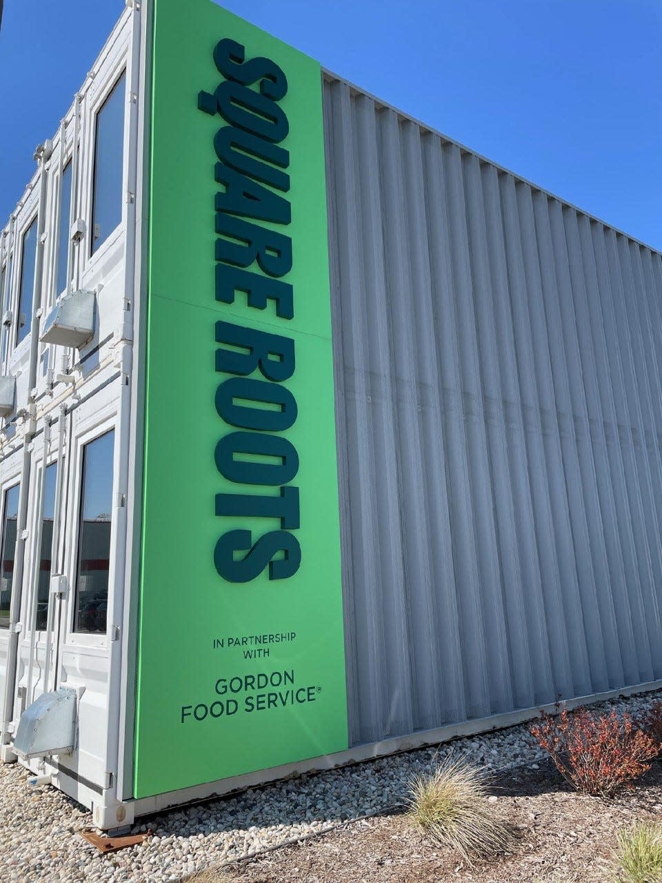 Square Roots' facility is built with shipping containers next to a Gordon Food Services facility. The partnership allows for delivery and connection to restaurant clients in addition to grocers.