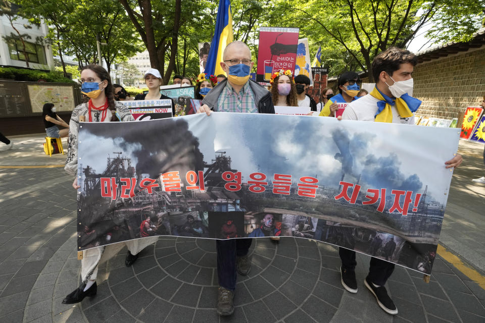 FILE - People march during a rally against Russia's invasion of Ukraine near the Russian Embassy in Seoul, South Korea, May 22, 2022. The banner reads "Let's protect Mariupol's hero." Nuclear Russia's pillaging of non-nuclear Ukraine is rattling what's already a destabilizing moment in nuclear nonproliferation efforts. Some former leaders in Asia have cited the Ukraine conflict as evidence it's time for nations there to think about getting nukes of their own. (AP Photo/Ahn Young-joon, File)