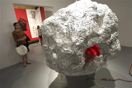 A woman views "Silver Ball" during an exhibition of work by the late artist Mike Kelley during a media preview at The Geffen Contemporary at The Museum of Contemporary Art in Los Angeles, California March 28, 2014. REUTERS/Jonathan Alcorn