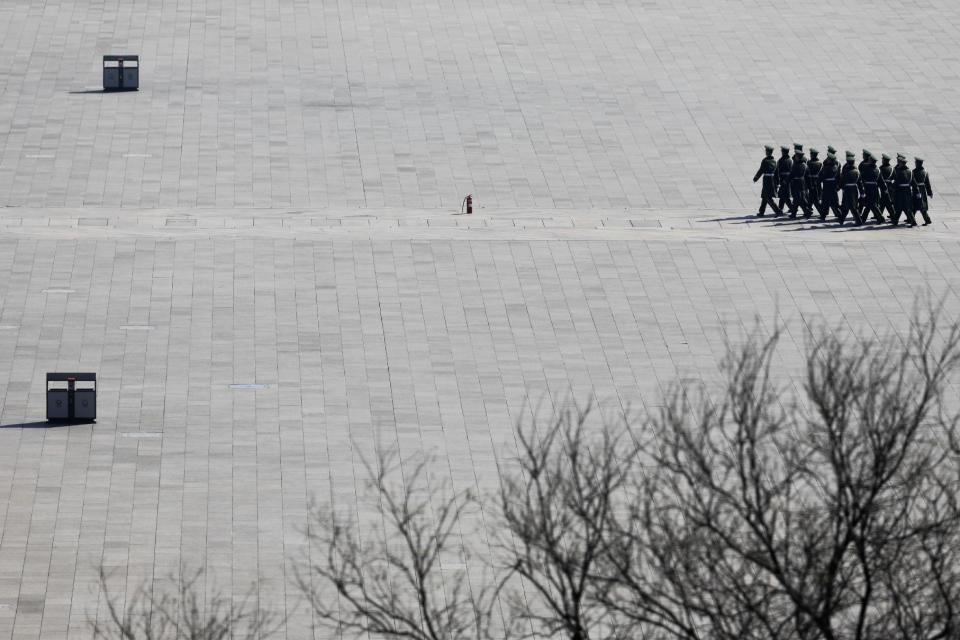 In this Friday, March 10, 2017 photo, Chinese paramilitary policemen march near a fire extinguisher sit in the middle of Tiananmen Square during the annual legislature meetings held at the Great Hall of the People in Beijing. Because safety comes first, fire extinguishers are ubiquitous in and around Beijing’s Great Hall of the People during the annual sessions of China’s ceremonial parliament and its official advisory body. That’s partly for standard purposes of preventing any sort of fire-related emergency that could harm the participants and mar the proceedings. (AP Photo/Andy Wong)