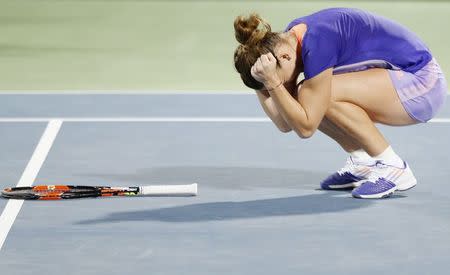 Romania's Simona Halep celebrates after winning the singles tennis final match at the WTA Dubai Tennis Championships February 21, 2015. REUTERS/Ahmed Jadallah