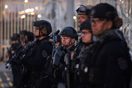 U.S. Customs and Border Protection (CBP) Special Response Team (SRT) officers stand guard at the San Ysidro Port of Entry after the land border crossing was temporarily closed to traffic from Tijuana, Mexico November 19, 2018. REUTERS/Adrees Latif