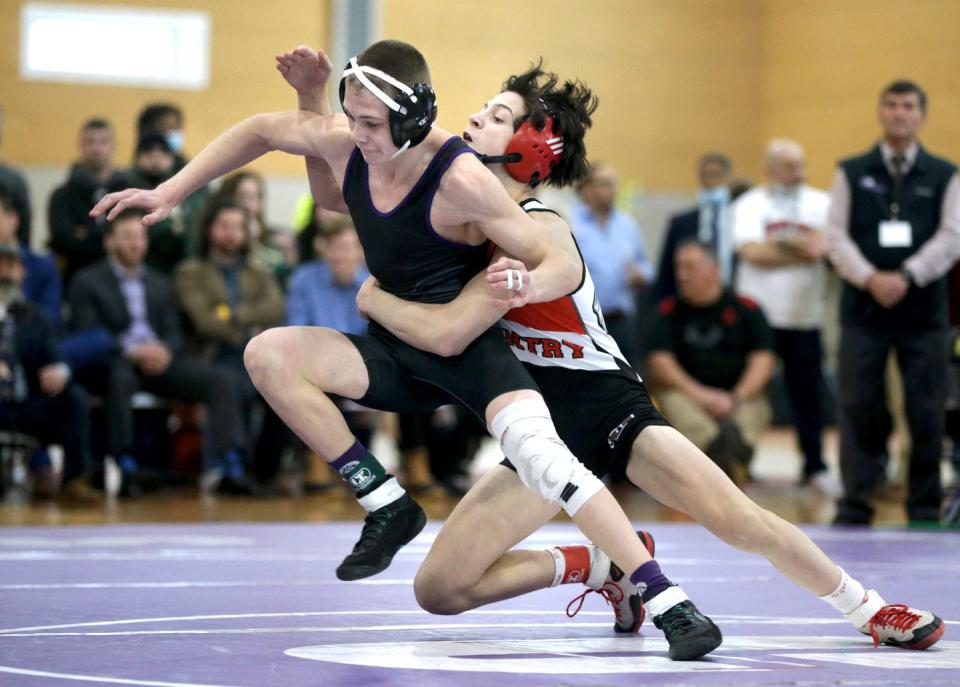 Mt. Hope's Andrew McCarthy tries to escape the grasp of Peyton Ellis of Coventry in their 113-pound match.