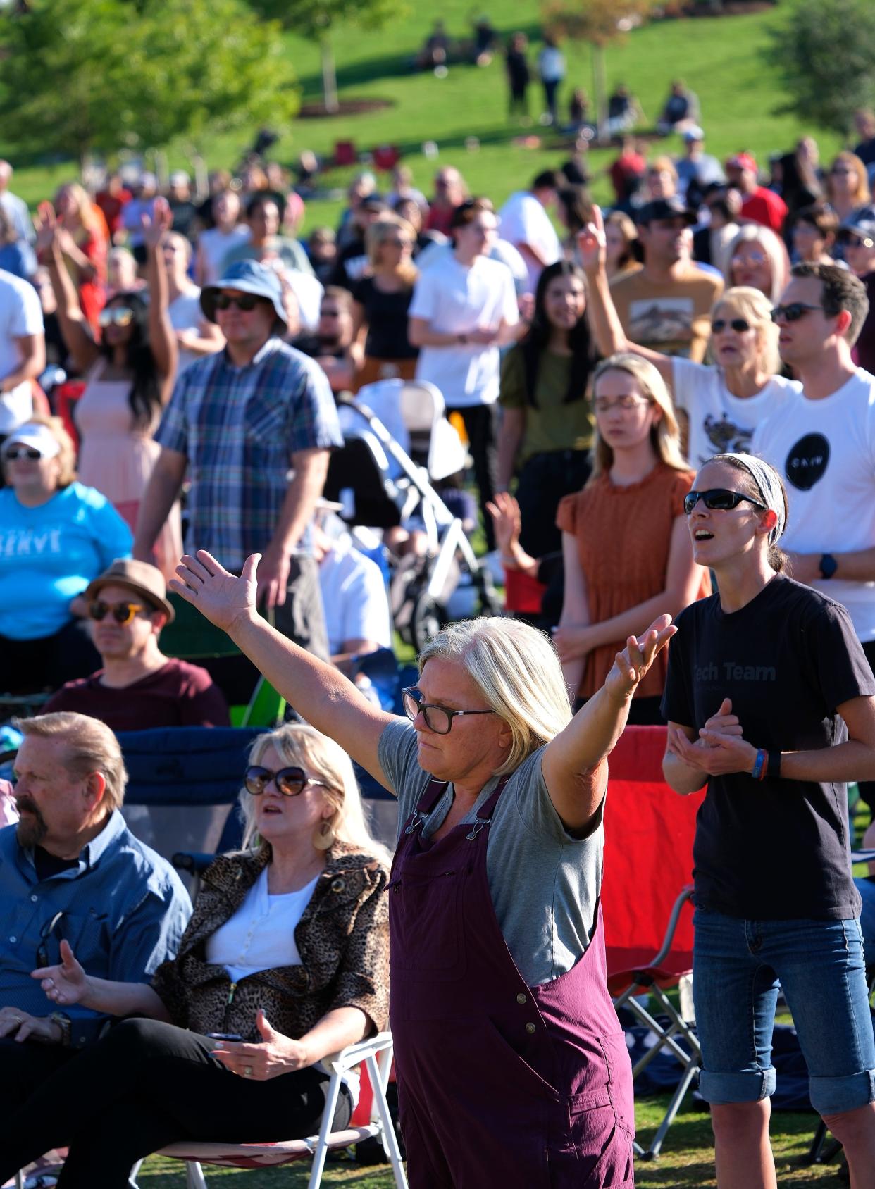 People sing songs of praise at "Unite OKC," a community worship service led by City Night of Worship, on Sunday Sept. 11, 2022, at Scissortail Park.