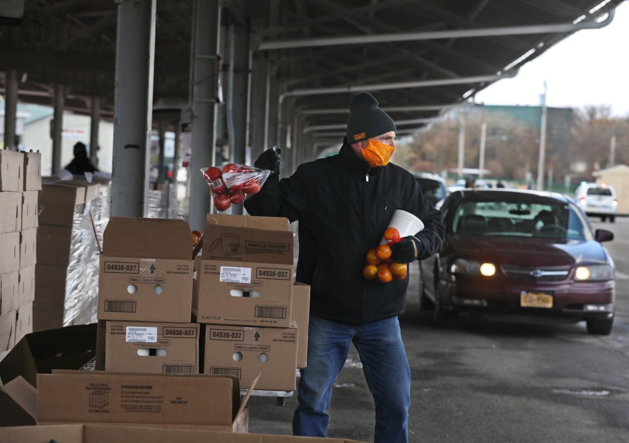 Foodlink and City of Rochester staff help distribute emergency food supply boxes at the Rochester Public Market