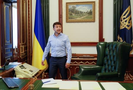 Ukraine's President Volodymyr Zelenskiy is seen at his desk in his office at the Presidential Administration building in Kiev