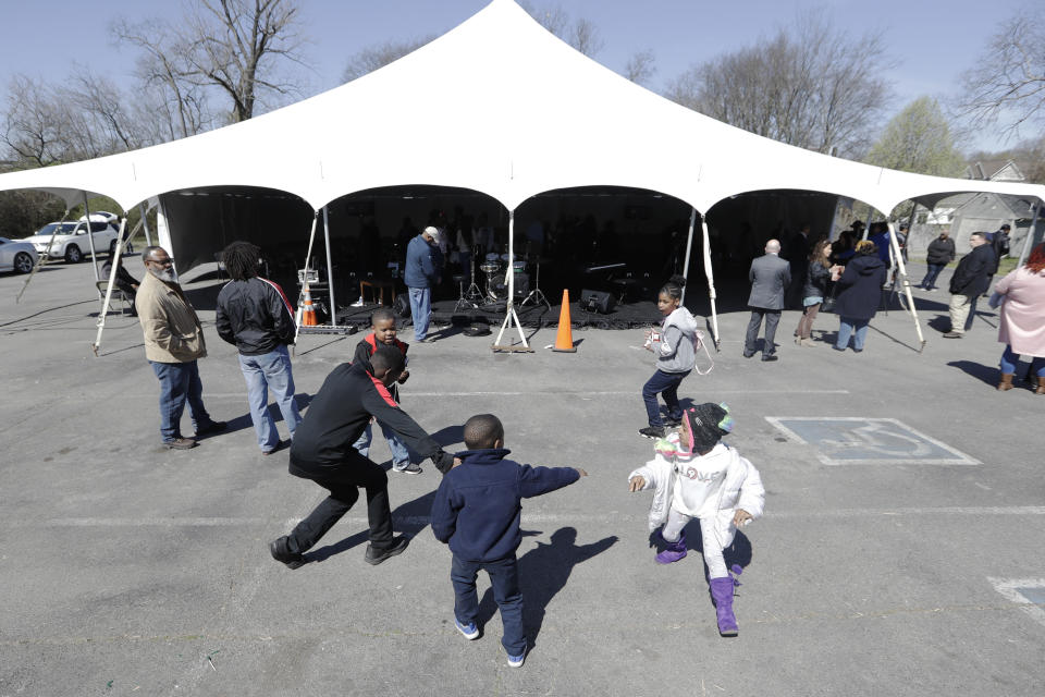 Children play after a worship service under a tent at Mount Bethel Missionary Baptist Church, Sunday, March 8, 2020, in Nashville, Tenn. The congregation held their Sunday service under the tent near the church facilities, which were heavily damaged by a tornado March 3. (AP Photo/Mark Humphrey)