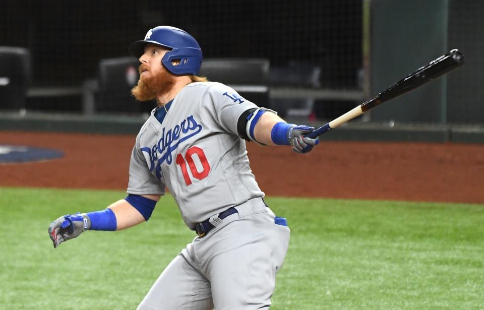 Justin Turner watches the trajectory of a ball he just hit.