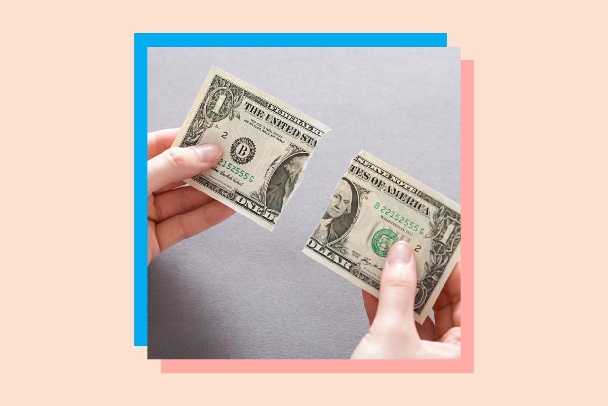 An image of a person splitting a dollar bill.