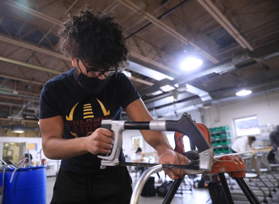 Julian Reyes cuts electrical conduit at Hudson Valley Community College in Troy on February 22, 2022. Reyes is a student in the college's Electrical Construction and Maintenance program. 