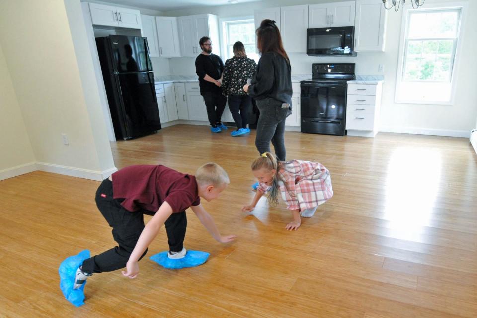 Connor and Briley O'Donnell frolic in their new Habitat for Humanity home.