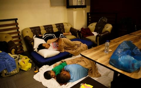 Guests sleep inside a hotel restaurant after the roof of their room was damaged by Typhoon Mangkut in Tuguegarao city - Credit: Aaron Favila/AP