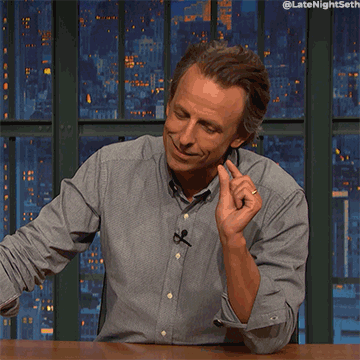 Seth Meyers with his fingers gesturing a small amount of something