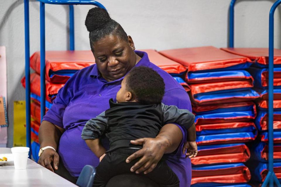 Preschool teacher Trini Edwards comforts Dedikashaun Jones, 2, during lunch break at Sunrise Early Learning and Development Center in Fort Worth on Thursday, Oct. 26, 2023.