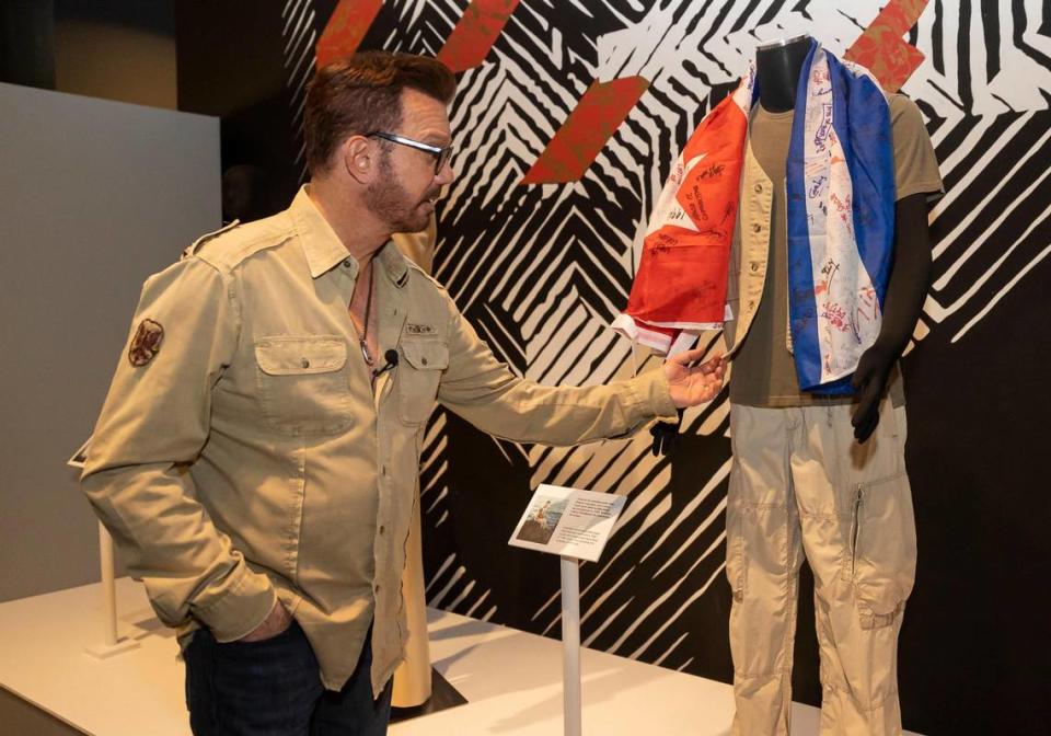 Willy Chirino tours ‘Willy Chirino: 50 Years of Music,’ on display at the HistoryMiami museum through Sept. 10. A flag signed by rafters at Guantánamo base is displayed next to the clothes Chirino wore to his concert in 1994.