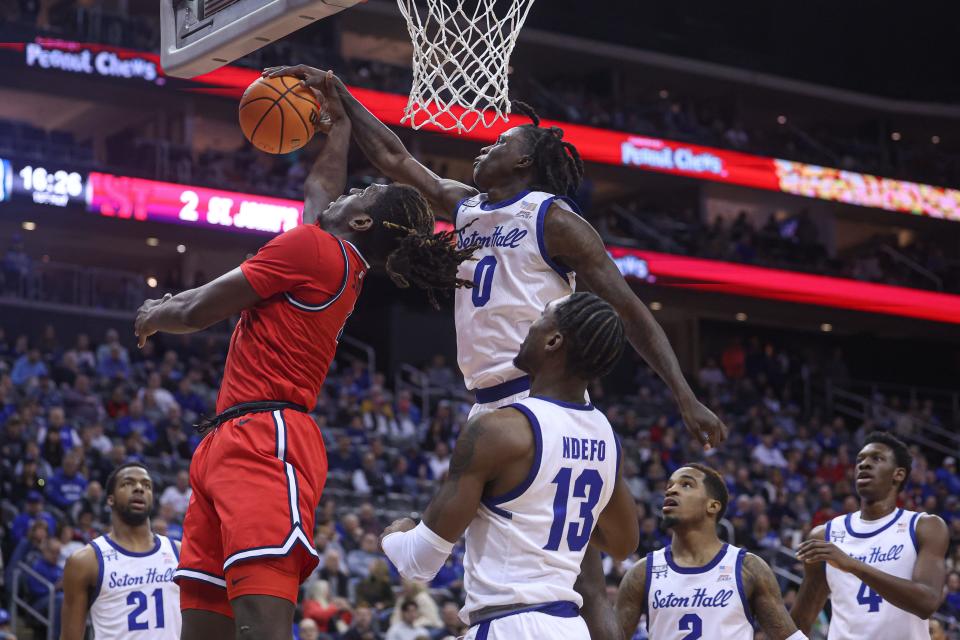 Dec 31, 2022; Newark, New Jersey, USA; St. John's Red Storm forward O'Mar Stanley (4) battles for a rebound against Seton Hall Pirates guard Kadary Richmond (0) and forward KC Ndefo (13) during the first half at Prudential Center.