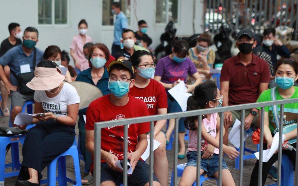 People wait in line in Hanoi for Covid-19 tests - Hau Dinh/AP