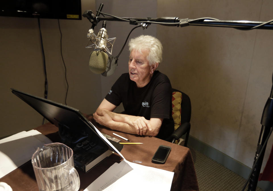 Singer Graham Nash prepares during the recording session for the audio book version of his "Wild Tales: A Rock & Roll Life" autobiography, in New York, Thursday, July 25, 2013. (AP Photo/Richard Drew)