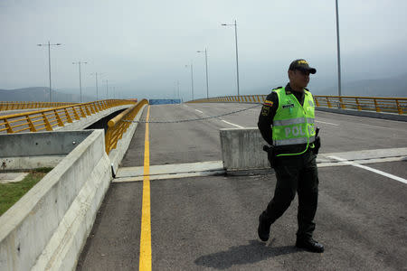 A police officer walks on the Tienditas cross-border bridge between Colombia and Venezuela, in Cucuta, Colombia February 6, 2019. REUTERS/Carlos Eduardo Ramirez