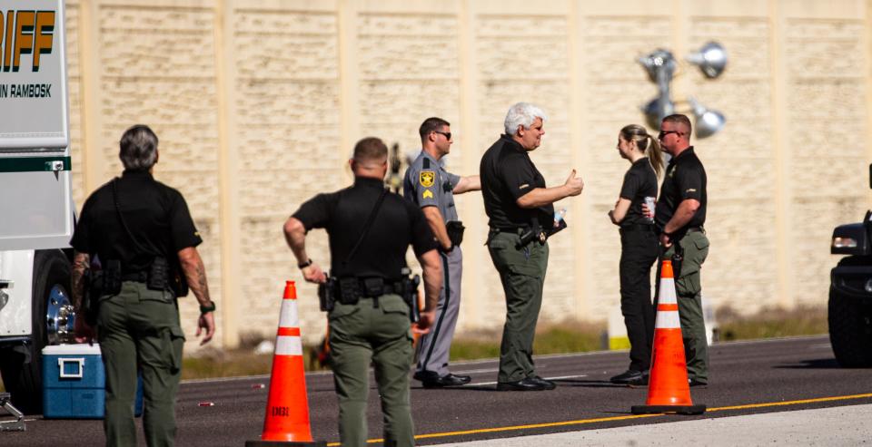 Emergency officials work the scene of a plane crash on I-75 in Naples near exit 105 on Saturday, Feb. 10, 2024. The plane carrying five people crashed on Friday, Feb. 9, 2023. Two people have been confirmed dead.