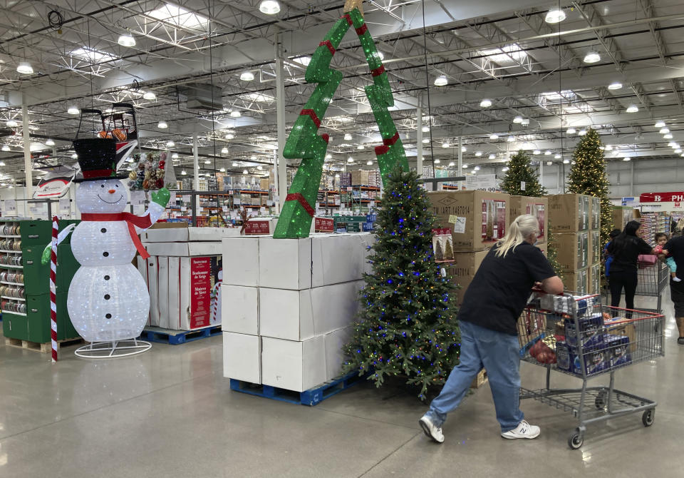 FILE - Shoppers pass by display of Christmas items for sale in a Costco warehouse Wednesday, Sept. 28, 2022, in Thornton, Colo. Consumers have proven resilient through the ups and downs of the COVID economy. Their spending has driven a strong recovery -- and ignited inflationary pressures. (AP Photo/David Zalubowski, File)