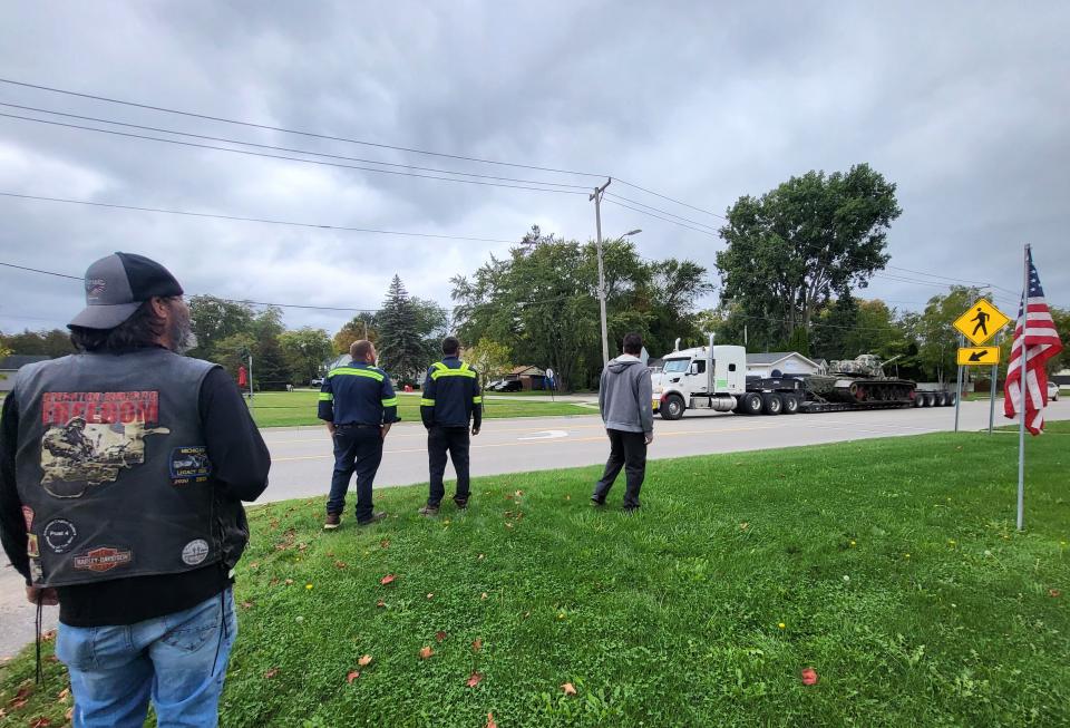 American Legion Post 449 members, crew from Steve's Towing, and others, watch as a large tank, which was decommissioned in the 1990s, arrives on Wednesday, Sept. 27, 2023, in Marysville.
