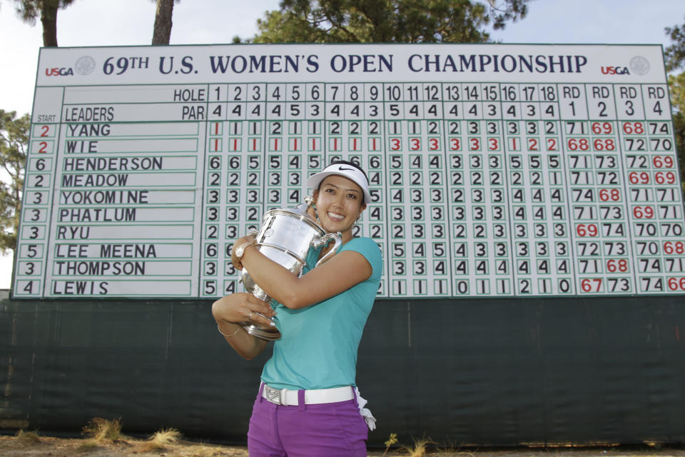 FILE - Michelle Wie pass with the trophy after winning the U.S. Women's Open golf tournament in Pinehurst, N.C., Sunday, June 22, 2014. Wie is one of five major champions at Pinehurst. (AP Photo/Bob Leverone, File)