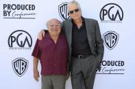 Danny DeVito and Michael Douglas have a friendly costar reunion at the Produced By Conference at Warner Bros. Studios in Burbank, California, on Saturday.