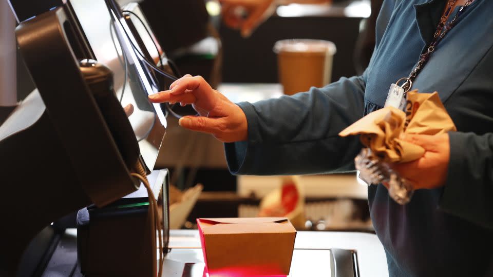 A customer uses a self checkout kiosk at Harmons Grocery store in Salt Lake City, Utah, U.S., on Thursday, Oct. 21, 2021. - George Frey/Bloomberg/Getty Images