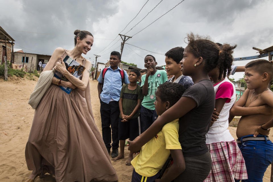 Angelina Jolie speaks with children in Riohacha, Colombia, on June 7, 2019. Jolie visited the children, who had fled Venezuela, in Brisas del Norte, an informal settlement inhabited by Colombian refugees who have returned to their country, as well as Venezuelans escaping a political and economic crisis back home.  / Credit: Andrew McConnell /UNHCR via Getty Images