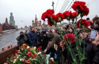 Russian mourners gather at the spot where opposition leader Boris Nemtsov was shot dead, near St Basil's Cathedral in Moscow, on February 28, 2015