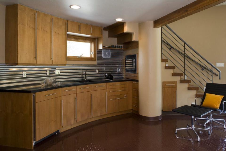 <p>The home's widest diameter measures 27 feet. Under the stairs, the kitchen follows the curvature of the house. </p>