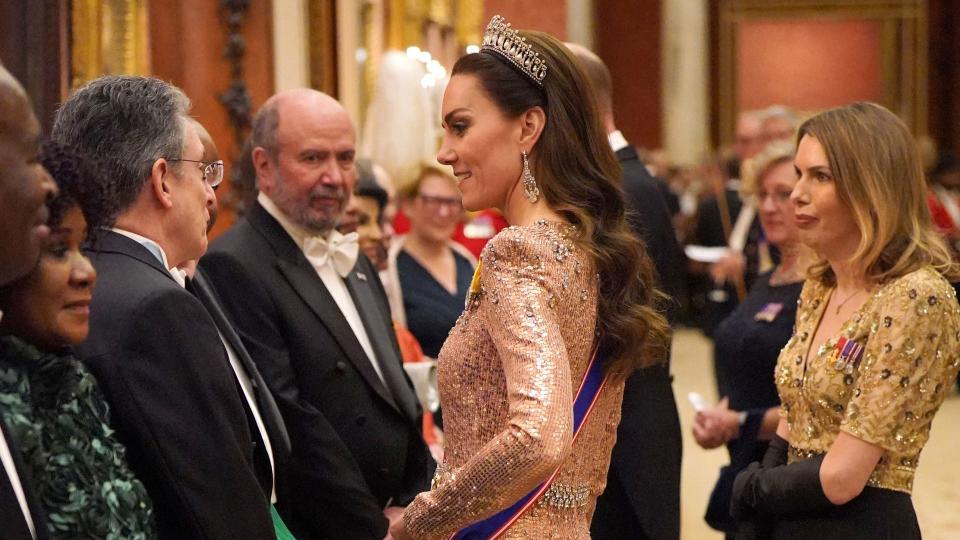 Kate Middleton in sequin dress chatting with guests at diplomatic reception