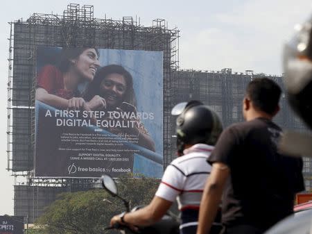 Motorists ride past a billboard displaying Facebook's Free Basics initiative in Mumbai, India, December 30, 2015. REUTERS/Danish Siddiqui