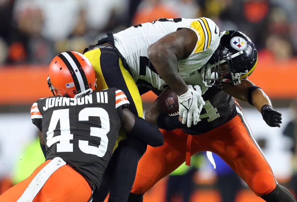 Browns safety John Johnson III (43) wraps up Pittsburgh Steelers running back Najee Harris during the first half Thursday, Sept. 22, 2022, in Cleveland.