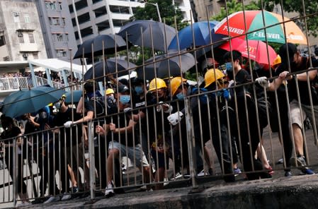 Demonstrators march to protest against the Yuen Long attacks in Yuen Long