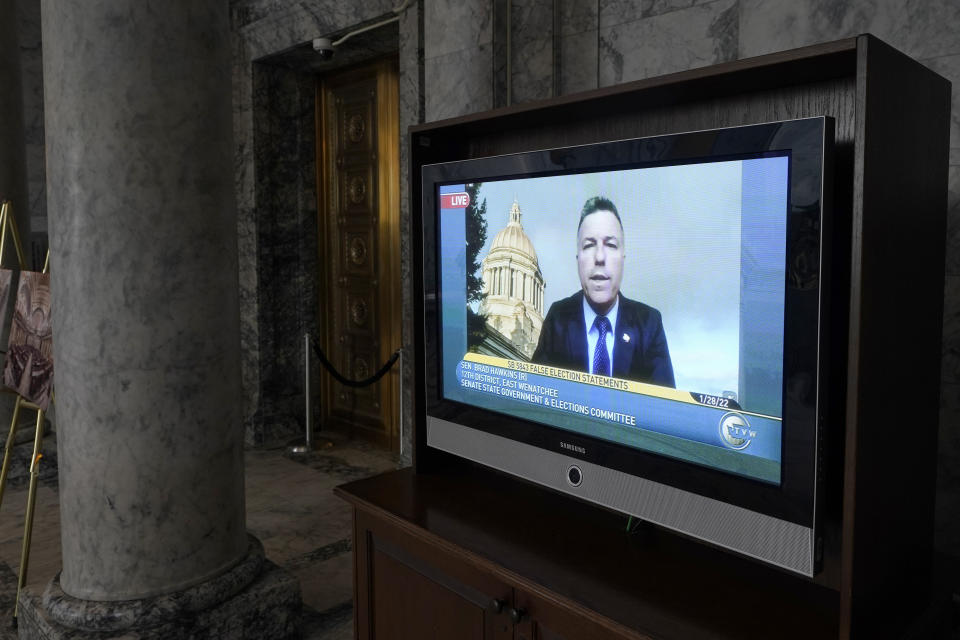 Sen. Brad Hawkins, R- East Wenatchee, a member of the Senate Government & Elections Committee, is shown on a video monitor outside the Senate chamber as he speaks remotely during a committee hearing on a bill that would make it a gross misdemeanor for elected officials or candidates to knowingly lie about election outcomes if those claims result in violence, Friday, Jan. 28, 2022, at the Capitol in Olympia, Wash. (AP Photo/Ted S. Warren)
