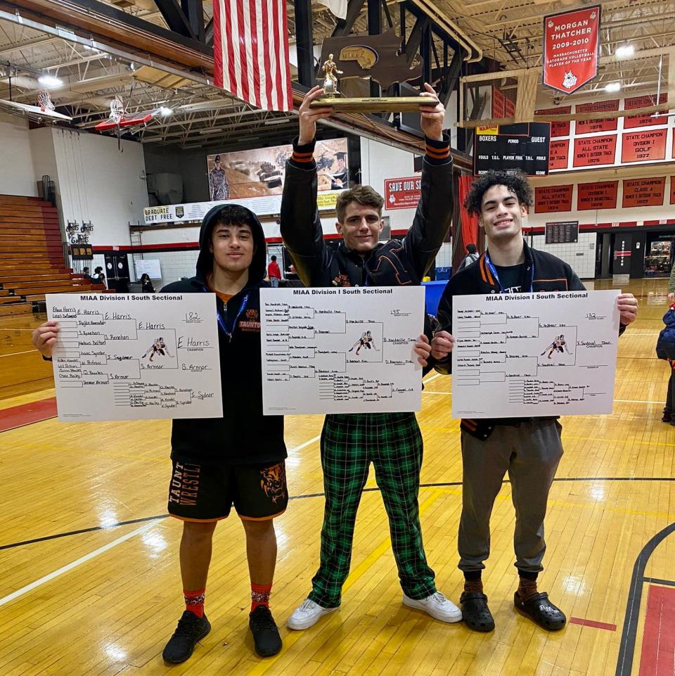 Taunton’s Ethan Harris (left), Ben Mandeville (center) and Xavier Sandoval hold up their winning brackets and the 2023 MIAA Division I South Sectional trophy.