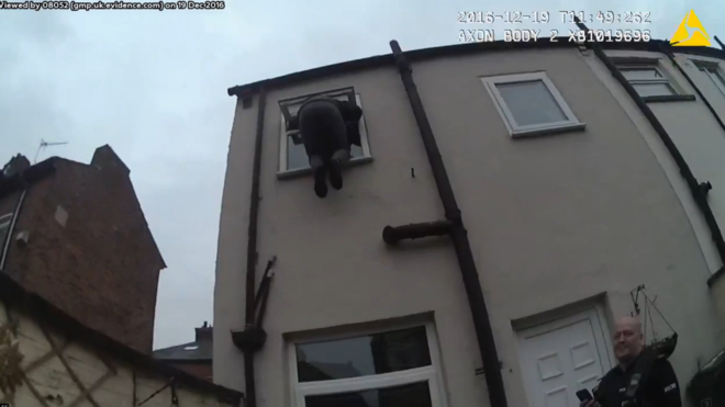 Stuck: Cops find burglar Sean Crawshaw in the bathroom window (GMP)