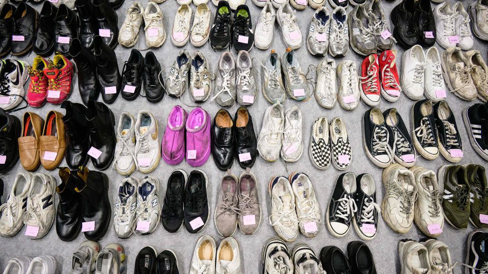 Shoes of victims laid out for identification by families, which were retrieved by police from the scene. - Anthony Wallace/AFP/Getty Images