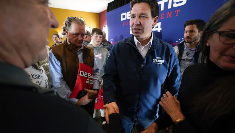 Republican presidential candidate Florida Gov. Ron DeSantis talks with audience members during a meet and greet on Nov. 3, 2023, in Denison, Iowa.